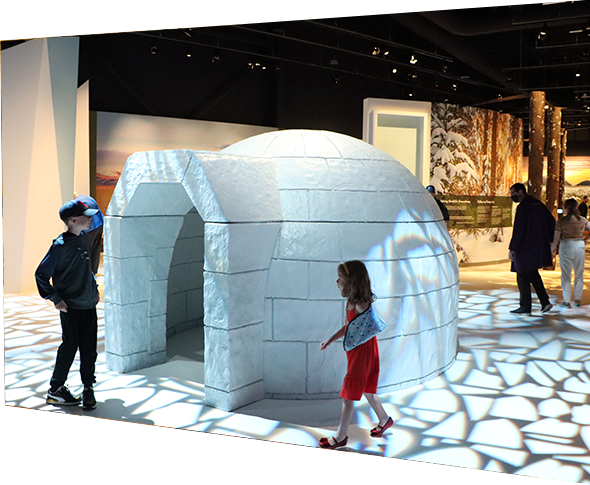 Children playing in an igloo installation