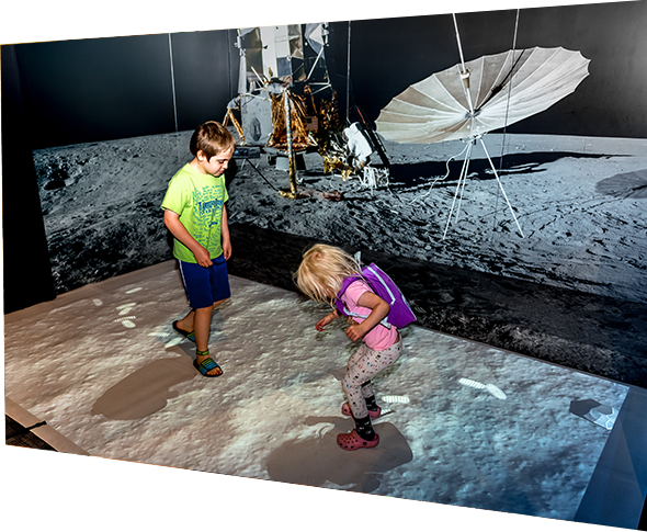Children playing in moon lander installation